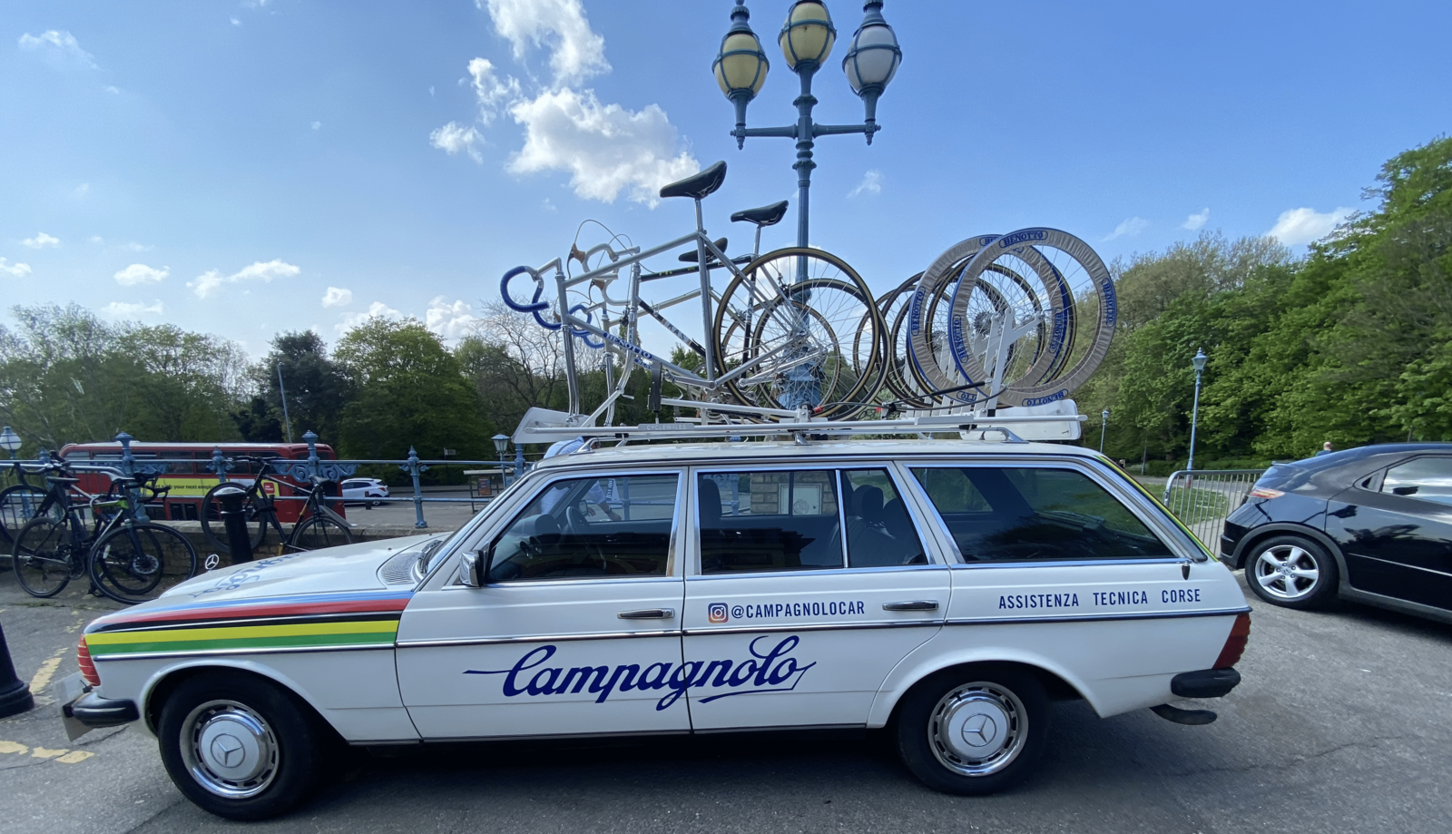An old-school car carrying old-school race bicycles.