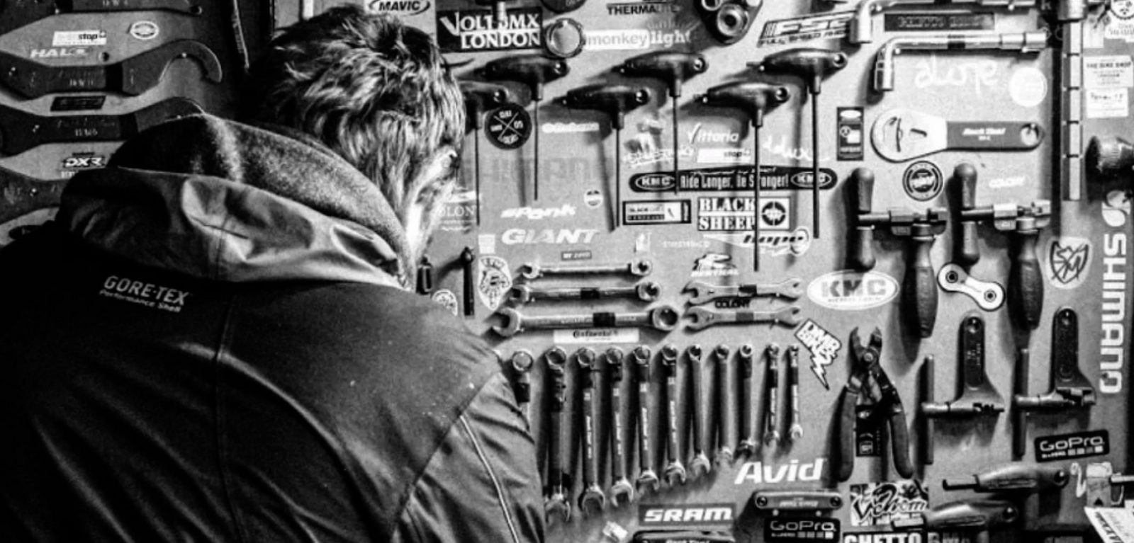 A black and white picture of Jay working in his workshop.